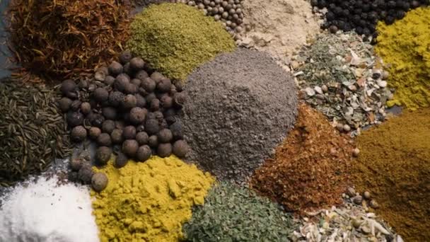 Various colored spices and seasonings rut in the frame top view — 图库视频影像