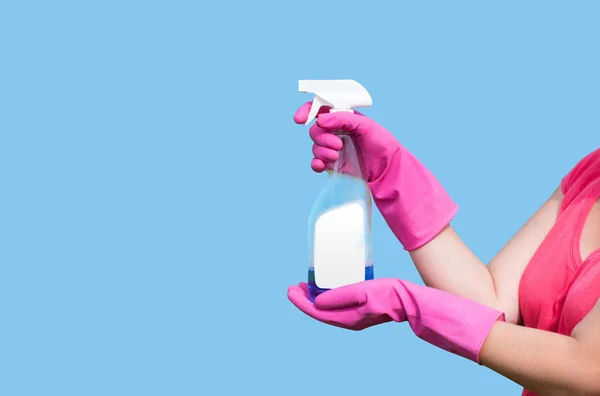 Cleaning product in the hands of the women in light blue background — Stock Photo, Image