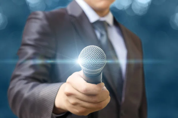 The man holds out a microphone . — Stock Photo, Image