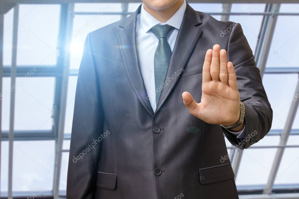 Businessman with forbidden gesture of the hand against .
