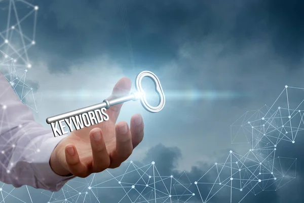Keywords in the hand of a businessman on the background network. — Stock Photo, Image