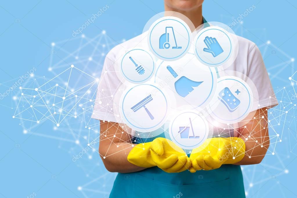 Worker shows icons of cleaning services .