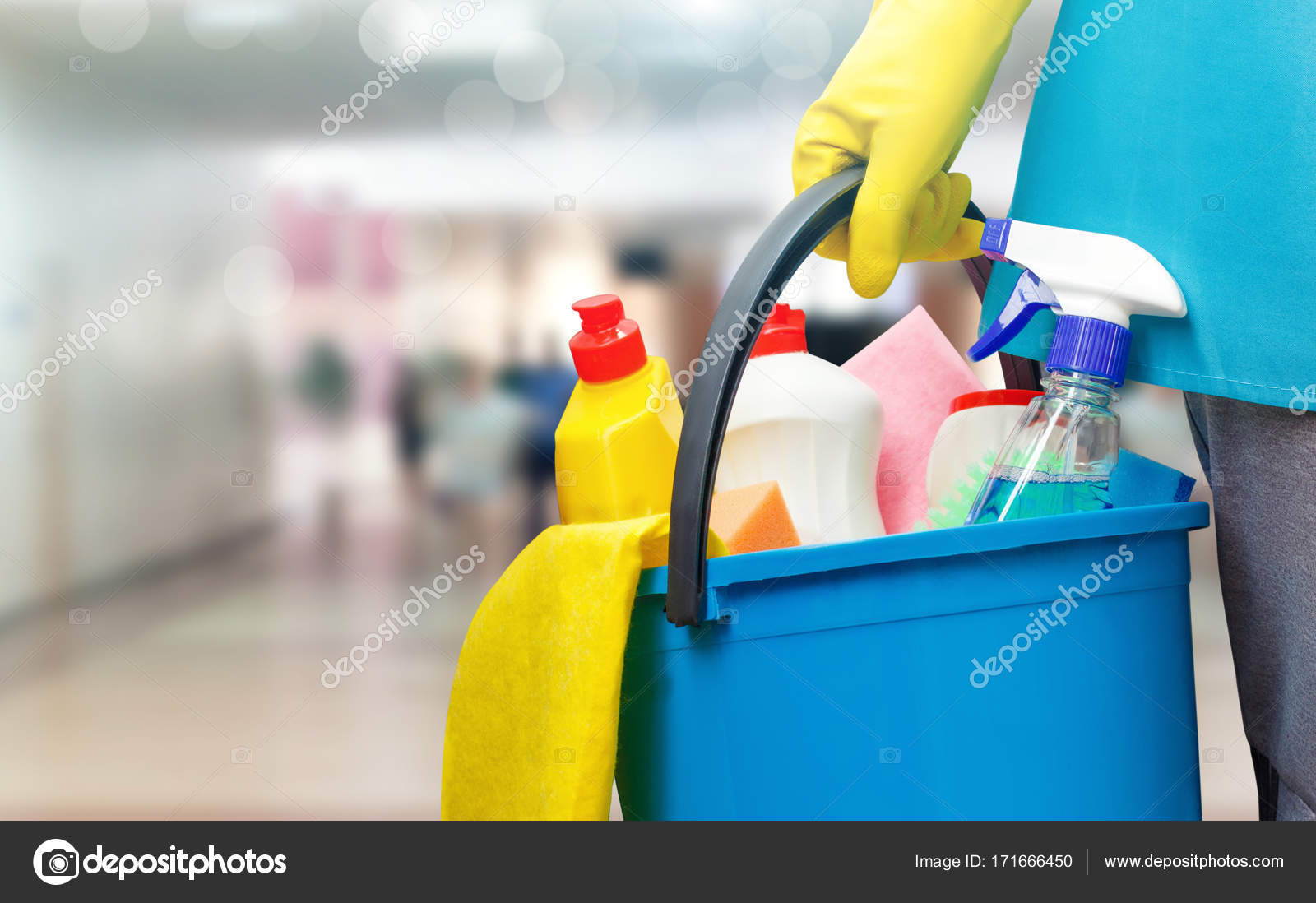 Cleaning lady with a bucket and cleaning products . Stock Photo by