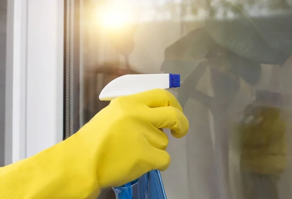 Cleaning lady cleaning a window .