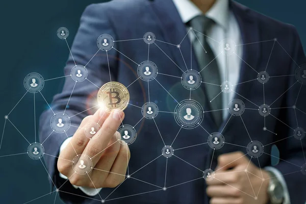 Businessman is holding a bitcoin as part of a business network . — Stock Photo, Image