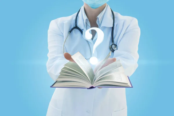 Doctor shows the book on a question mark .