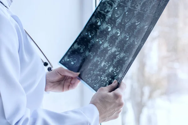 El médico mira la resonancia magnética del paciente en frente  . —  Fotos de Stock