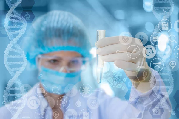 Doctor looks at the test tube with the test. — Stock Photo, Image