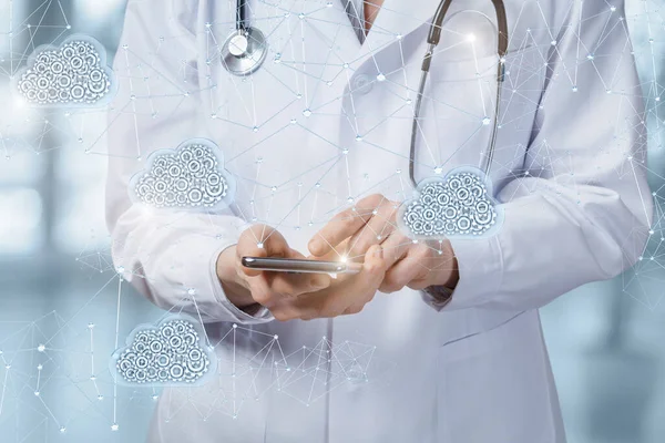 Cloud data storage in medicine.Doctor works on a mobile phone in data clouds.