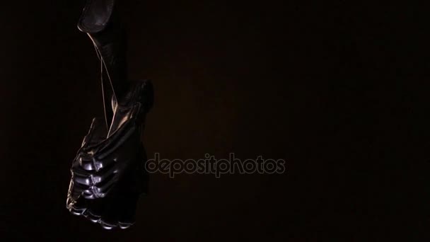 Mama fighting gloves hanging and rotating on black background. — Stock Video