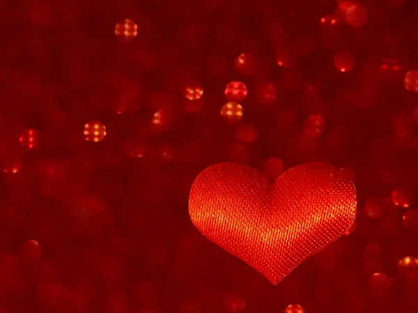 Corazón rojo sobre un fondo rojo borroso con bokeh. Desenfoque. Símbolo del amor. Día de San Valentín, cumpleaños, regalo . — Foto de Stock