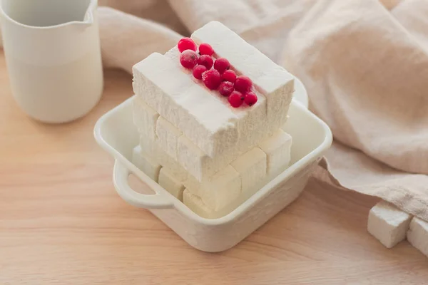 Handmade Apple pastille with fresh berries on a light background