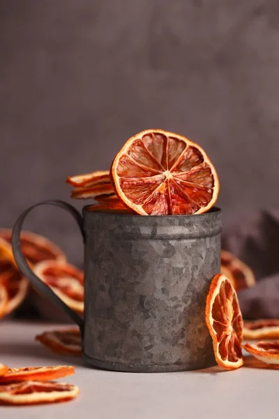 Dried fruit. Without sugar. Paste. Homemade sweets. Dried fruits. Healthy fruit snack. Tangerines in a vintage tin Cup on a dark background