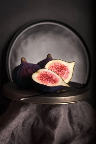 Figs in a section on a dark background. Bright ripe figs. Healthy diet. Still life with fruit