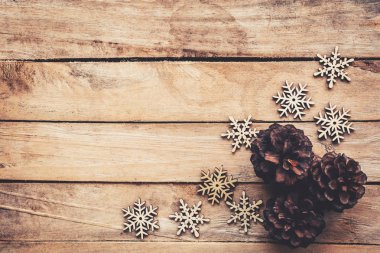Çam kozalakları ve kar taneleri için Noel arka plan ile ahşap üzerine