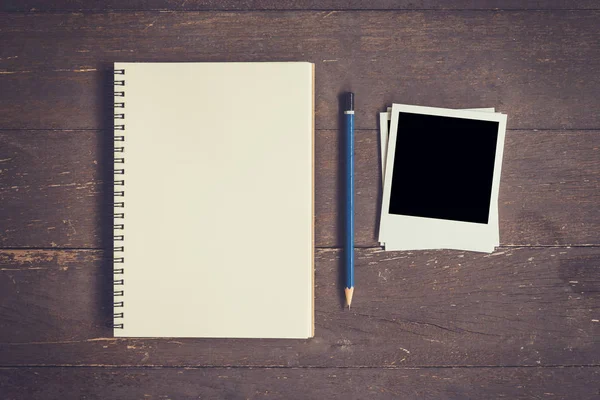 Blank Book open and photo frame on wood table with space. — Stock Photo, Image