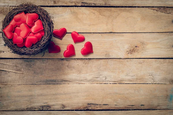 Red heart in the nest on wood background with space — Stock Photo, Image