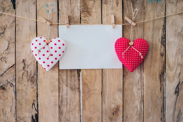 Two heart fabric and paper hanging on clothesline at wood backgr — Stock Photo, Image