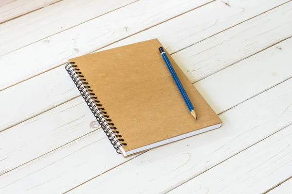 Brown notebook with blank pages and pencil on wood table — Stock Photo, Image