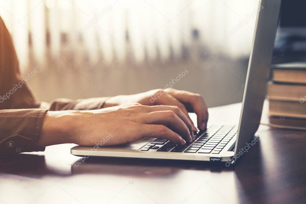 Young business man hand using computer laptop in the office with