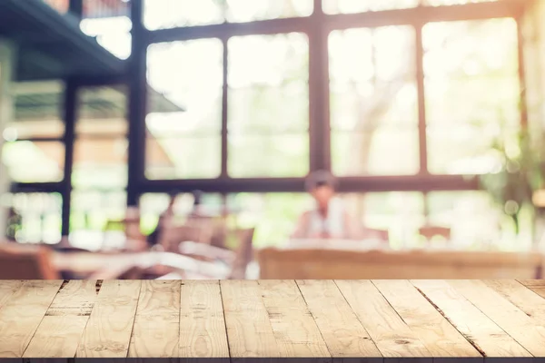 Tavolo in legno vuoto e sfondo sfocato: cliente al coffee sho — Foto Stock