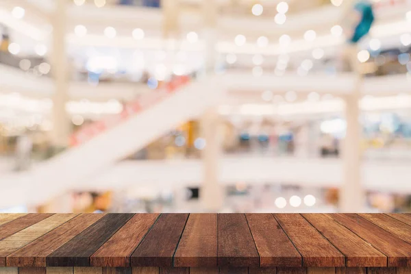 Empty wood table and blurred light table in shopping mall with bokeh background. product display template.