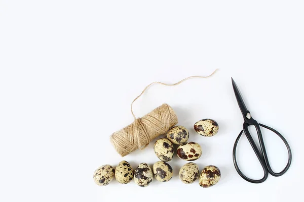 Easter, spring greeting card, invitation with quail eggs, black scissors and natural rope on white table. Feminine styled stock flat lay photo, top view. — Stock Photo, Image