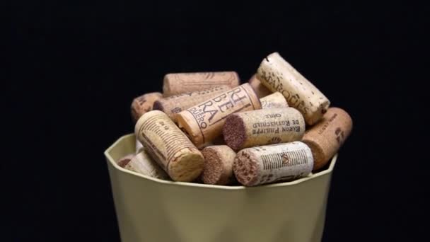 KIEV, UKRAINE - JANUARY 10, 2020: Rotating wine corks as a background. Multinational corking products with shallow focus on black background — Stock Video