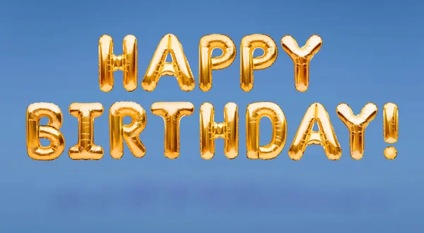 Words HAPPY BIRTHDAY made of golden inflatable balloons floating on blue background. Gold foil helium balloons forming phrase. Birthday congratulations concept, HBD phrase, happy birthday wishes.