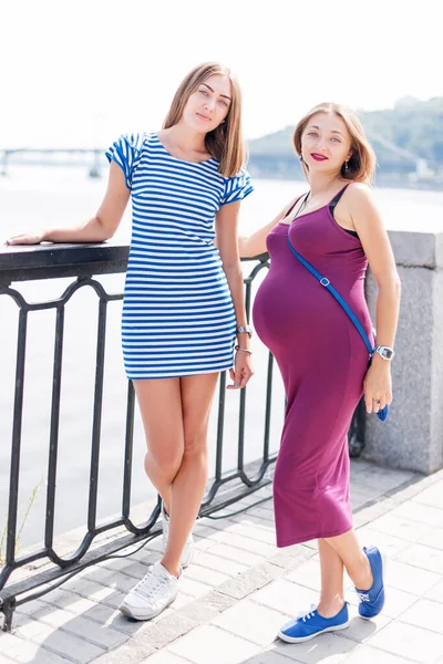 2人のきれいな女性が街の堤防 幸せな家族の上を歩く サセックス レズビアン ファミリー妊娠中のカップル — ストック写真