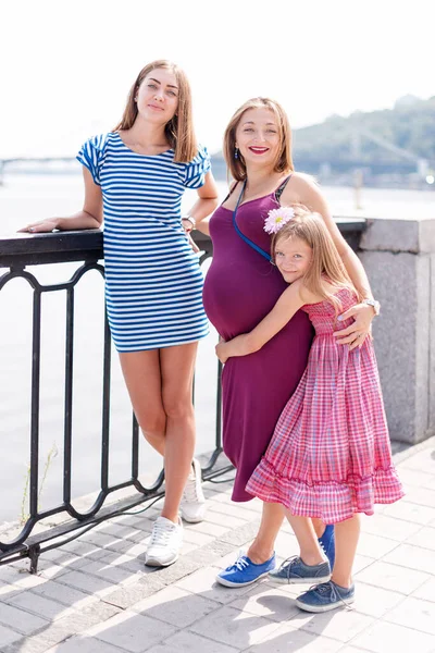 萨梅塞克斯的女同性恋家庭带着孩子在河边的公园里散步 有收养孩子的女同性恋者 幸福的家庭 有孩子的怀孕夫妇 — 图库照片