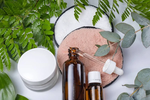 Organic bio cosmetics with herbal ingredients. Natural extract, oil, serum with fresh leaves. Flat lay, handmade beauty and spa, perfume or cream ingredients. Beauty, skin, hair or body care concept.