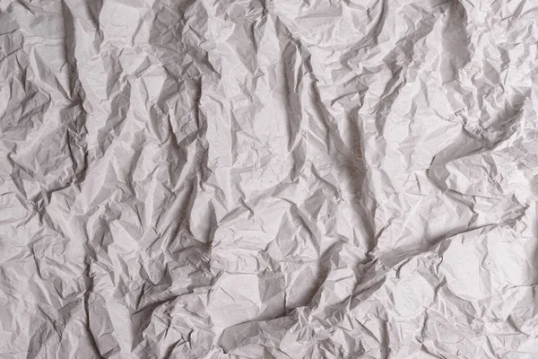 Textura de papel gris arrugado. Fondo de papel arrugado con grietas y torceduras . —  Fotos de Stock