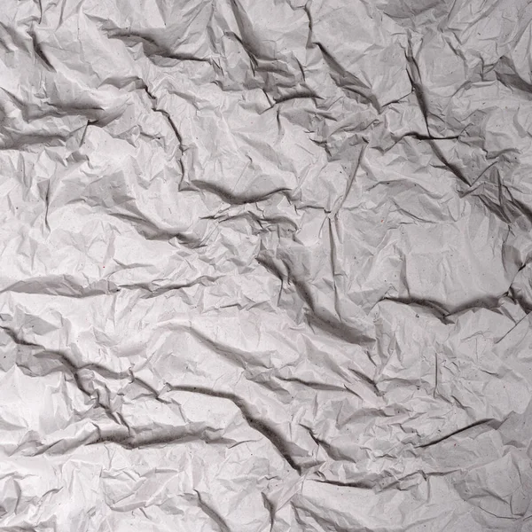 Crumpled gray paper texture. Wrinkled paper background with cracks and kinks.