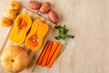 pumpkin halves and a round small pumpkin on a bamboo cutting Boa