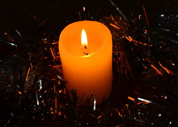 three candles on black background