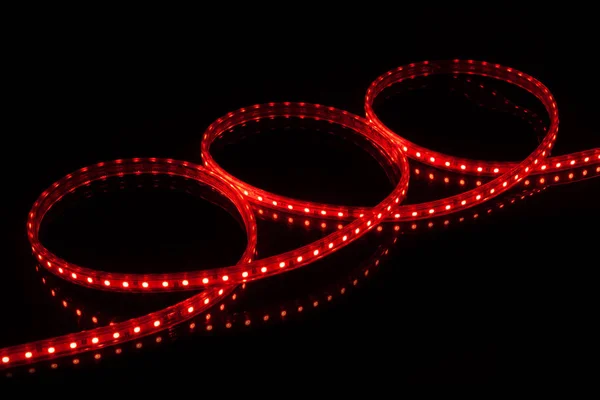 Red LED strip tape on black background.