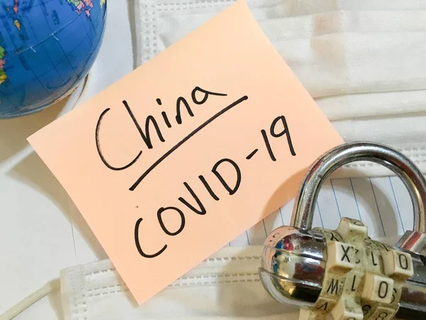 China virus Coronavirus COVID-19 infection lockdown COVID respiratory disease influenza effect on surgical mask and earth globe background