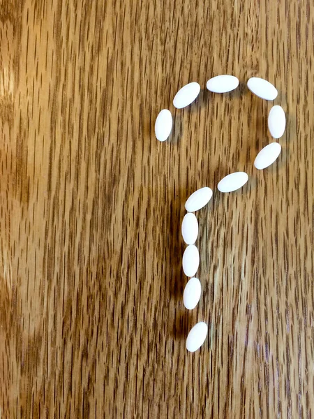 Medicine pills making question mark