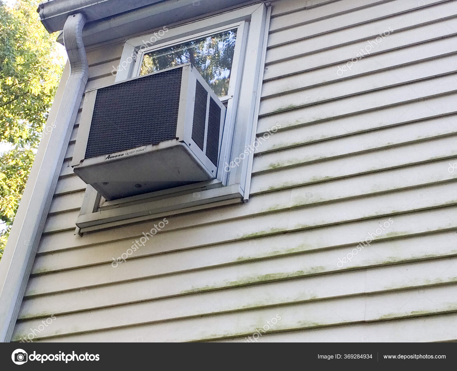 Air conditioner window unit with moldy on vinyl siding — Stock