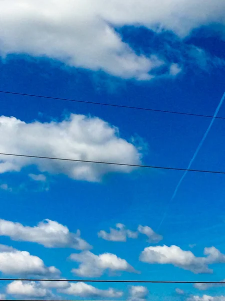 Blue sky white clounds with power lines on sunny day jet stream — Stock Photo, Image