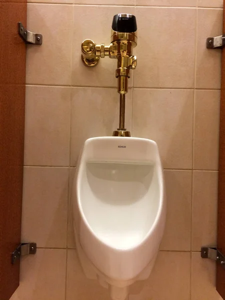 Urinal in mens public restroom bathroom with luxury gold plumbing — Stock Photo, Image