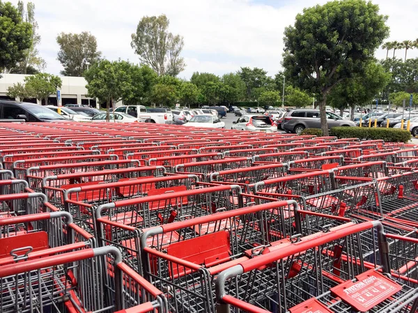 Carros de compras de metal rojo y plata organizados en filas de masas —  Fotos de Stock