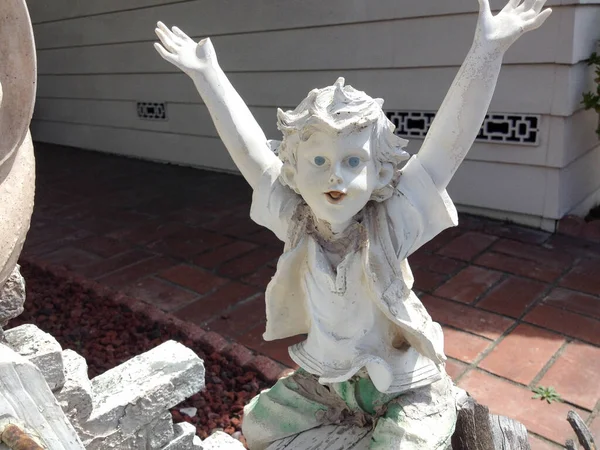 boy child garden statue smiling white concrete