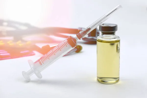 Vaccine vial with syringe over medical treatment on white background. Vaccination or antibiotic health care. Virus epidemic dangerous concept. Sun light effect.