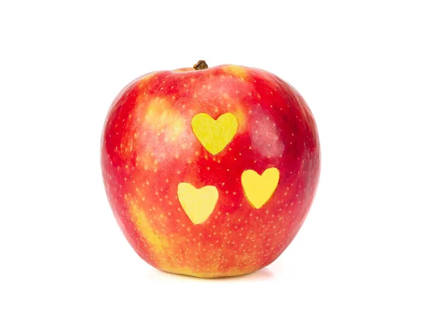 Fresh red apple with yellow hearts on its side isolated on white — Stock Photo, Image