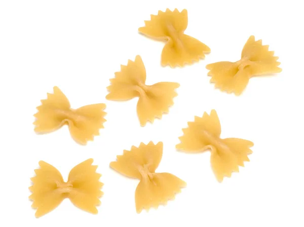 Raw italienska pasta farfalle på vit bakgrund — Stockfoto