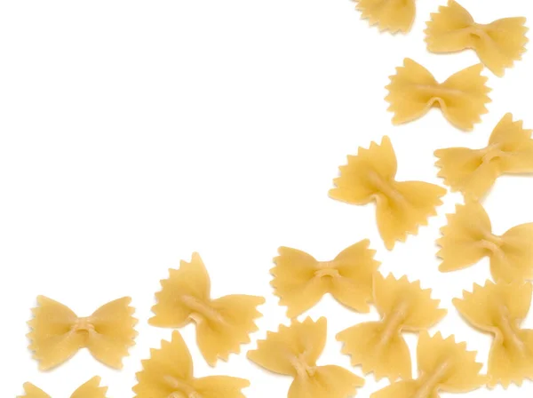 Raw italienska pasta farfalle på vit bakgrund — Stockfoto
