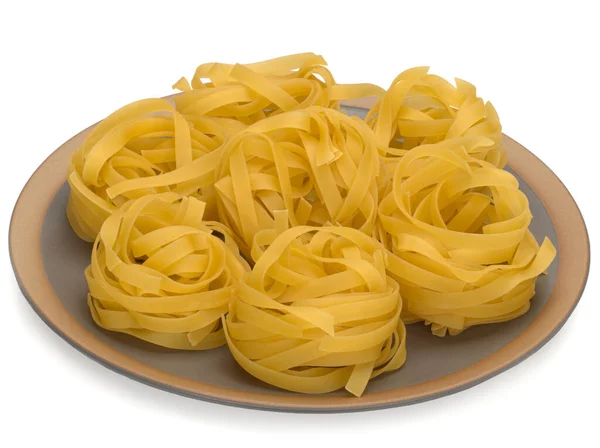 Italien torka rå pasta tagliattele på plattan. Närbild på vit bakgrund — Stockfoto