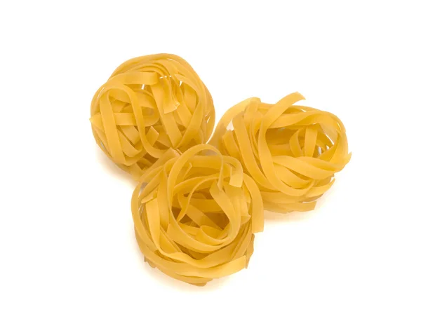 Italy dry raw pasta tagliattele close-up on white background — Stock Photo, Image